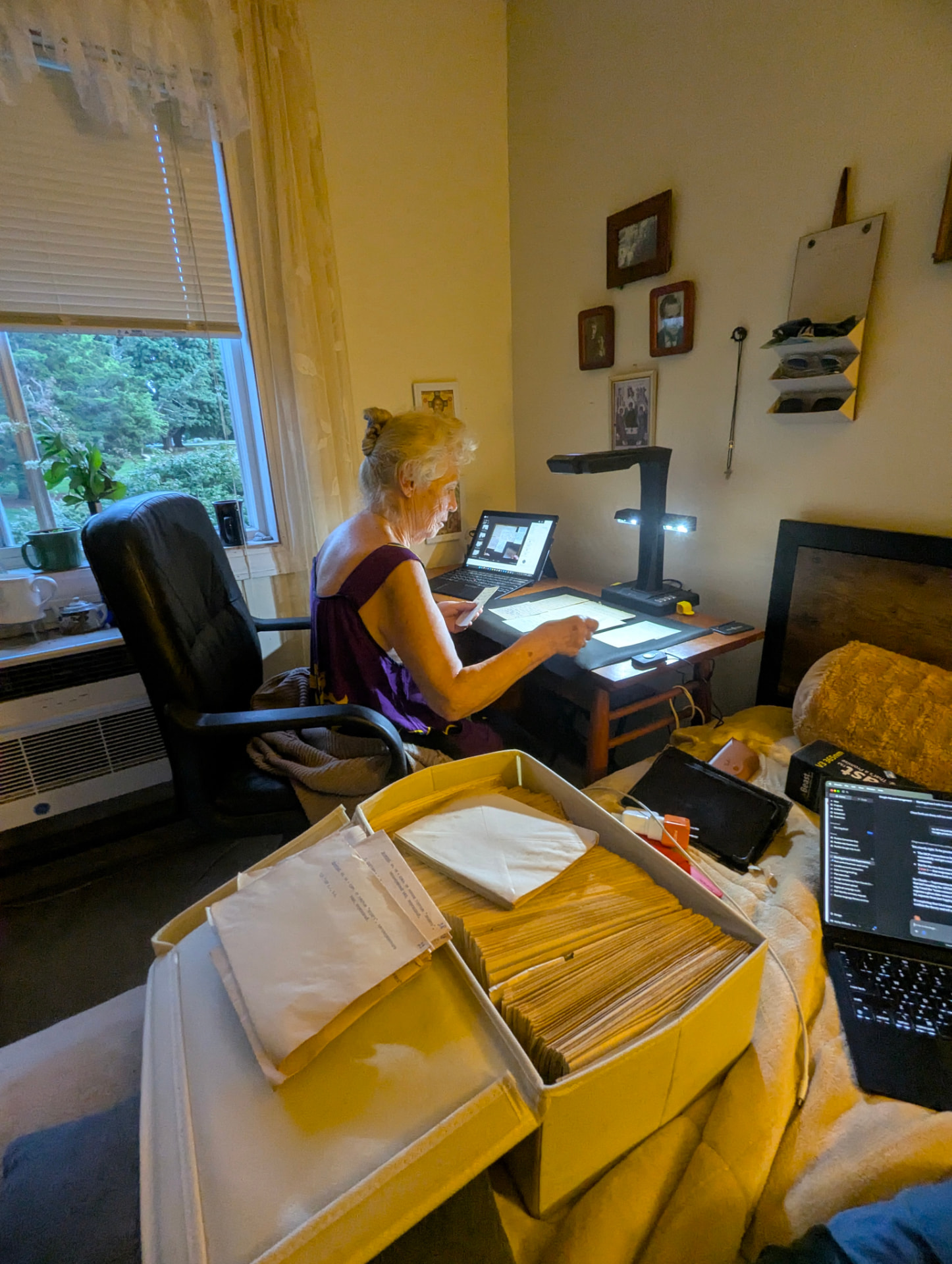 The current digitization workstation: original cards and binders being photographed page by page, preserving the archive's original order.